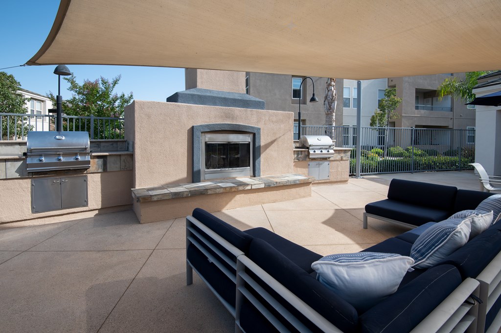 A patio with a couch and a  fireplace.