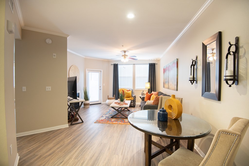 A dining room with a glass table and chairs.
