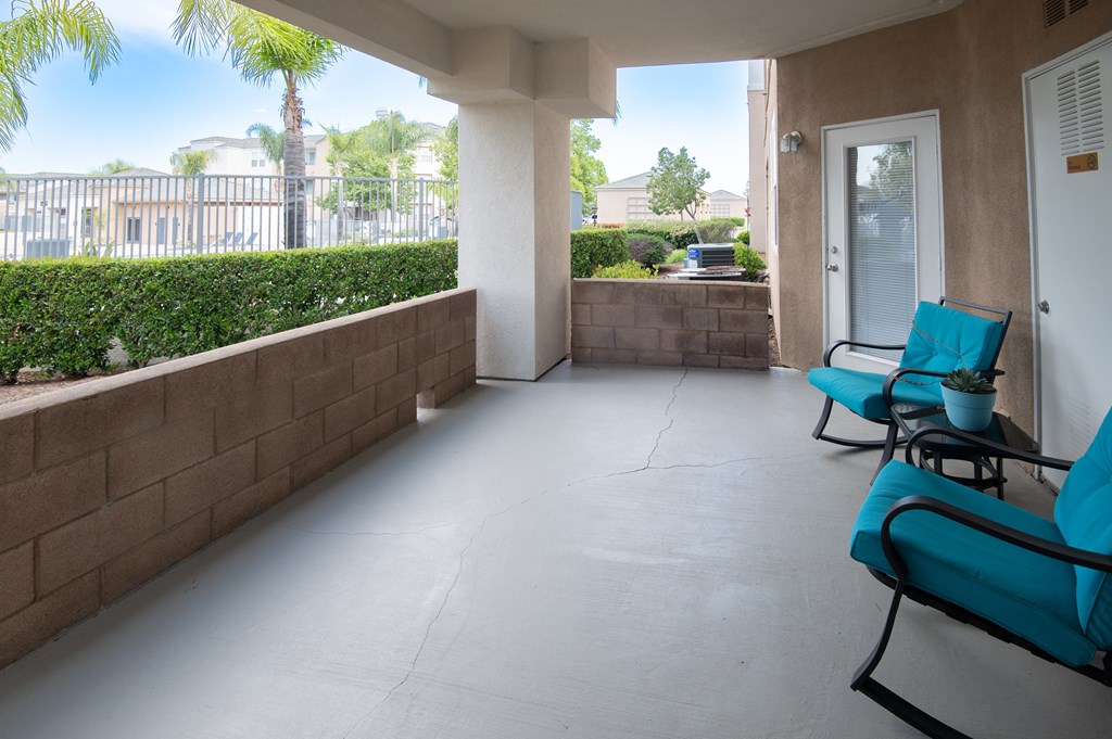 A patio with two chairs and a table.
