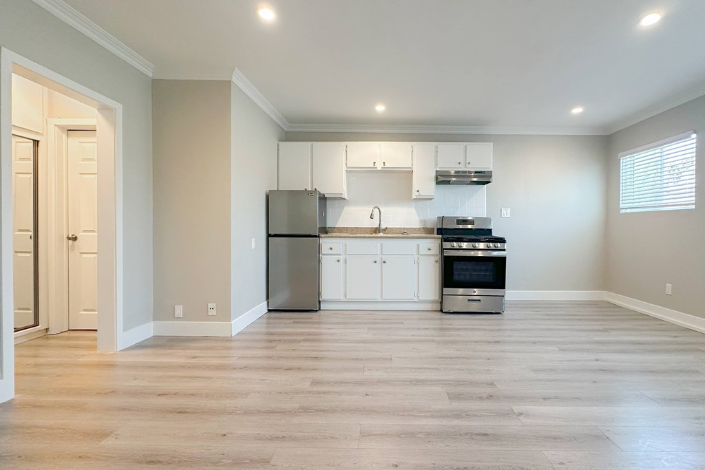 A kitchen with white cabinets and stainless steel appliances.