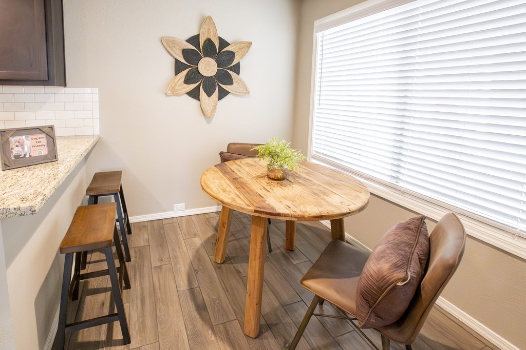 A brown chair sits in front of a wooden table.