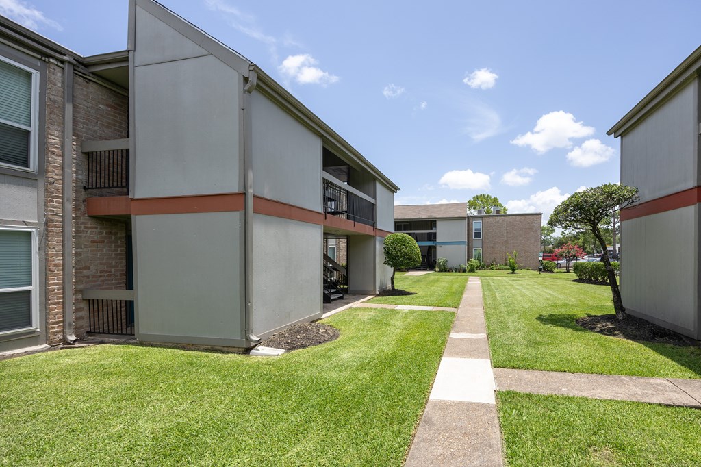 A sunny day at the apartment complex with a clear blue sky.