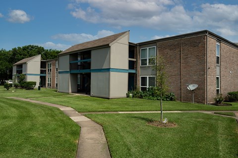 A building with a green lawn in front of it.