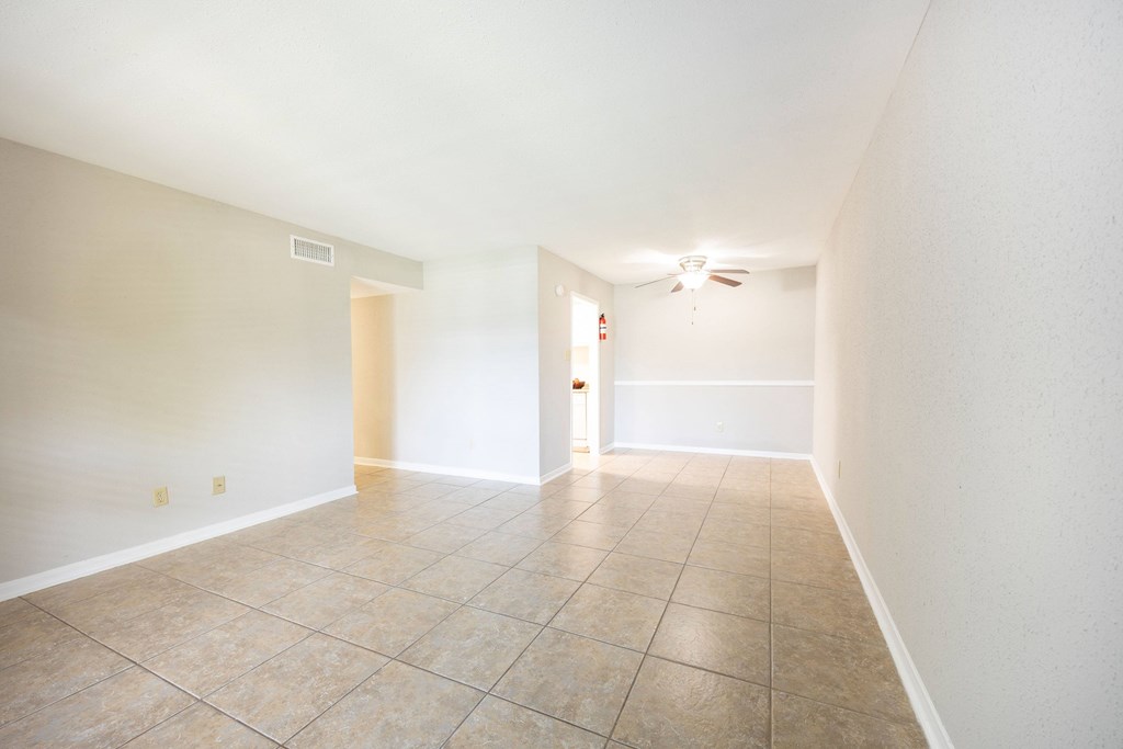 A room with a tiled floor and a ceiling fan.