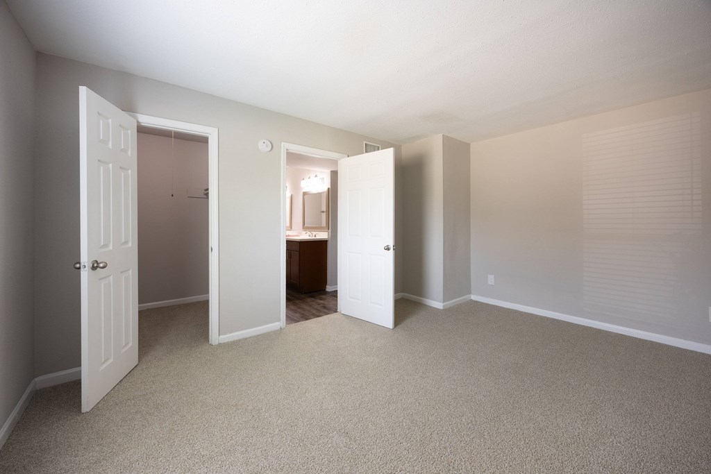 A room with carpeted floors and white walls.