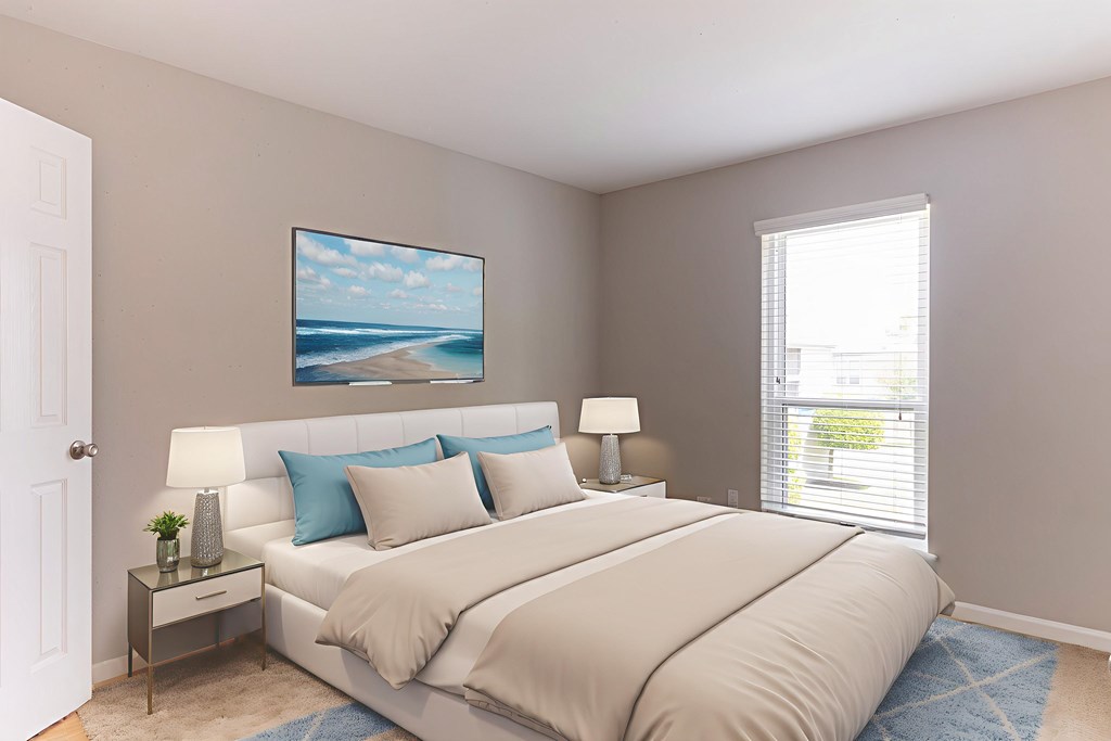 A bedroom with a large bed and a painting on the wall.