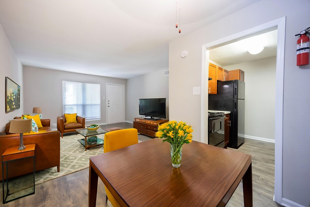 A living room with a brown table and yellow chairs.