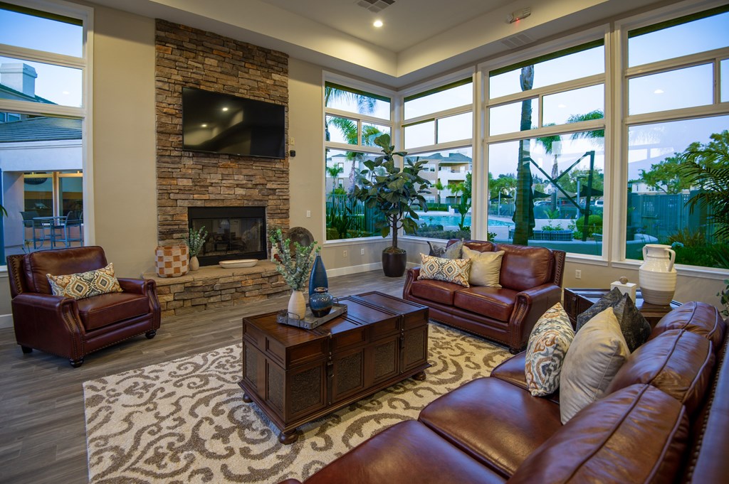 A living room with a fireplace and leather furniture.