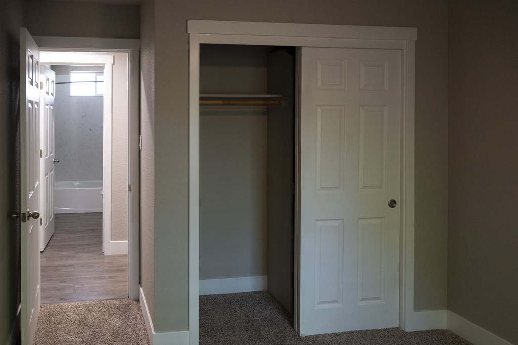 A white door is open to a hallway.