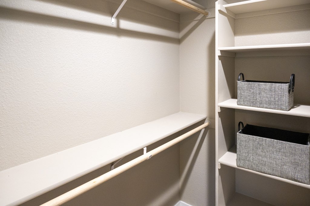 A white pantry with a shelf and a basket.