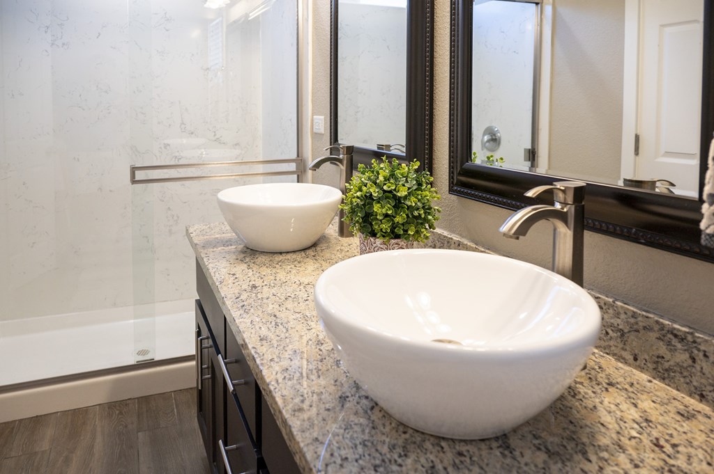 A bathroom with a white sink and a mirror.