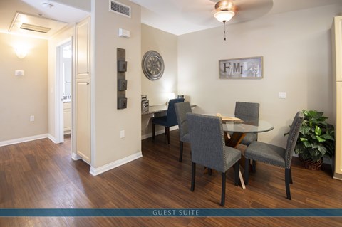 A dining room with a table and chairs.