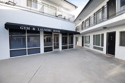 A gym and laundry room is located on the first floor of a building.