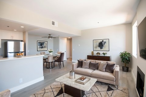 A modern living room with a white couch and a coffee table.