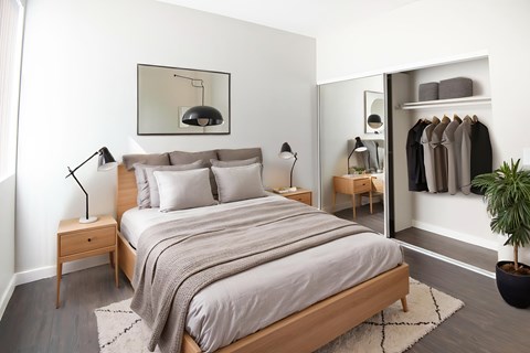 A bedroom with a large bed and a wardrobe.