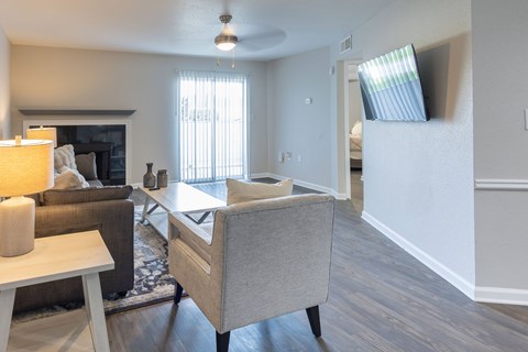 A living room with a grey couch and a wooden coffee table.