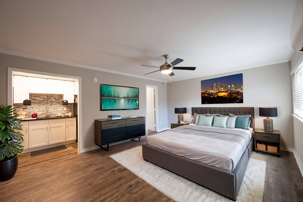 a bedroom with a large bed and a ceiling fan