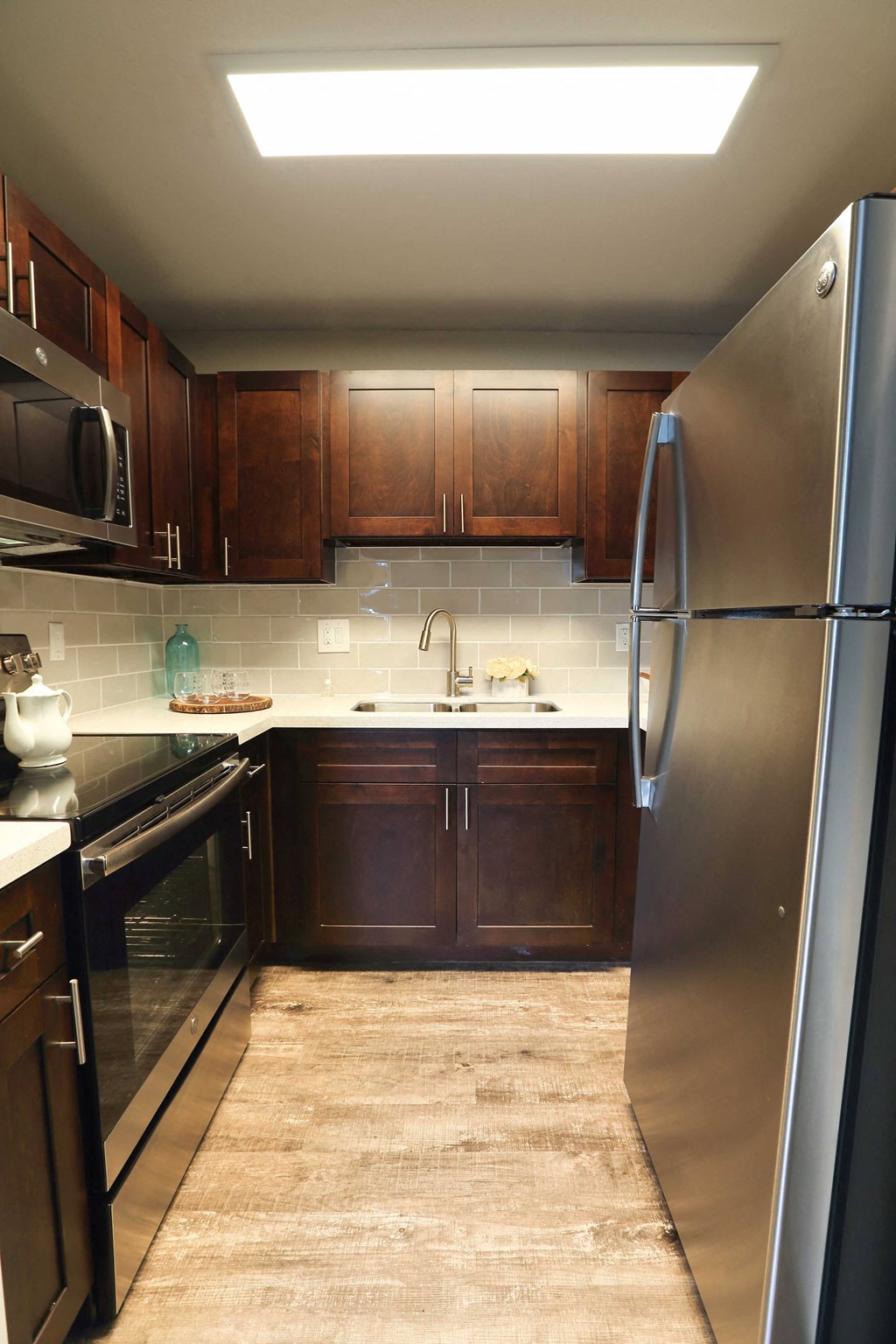 Kitchen featuring wood floors stainless appliances and granite counters