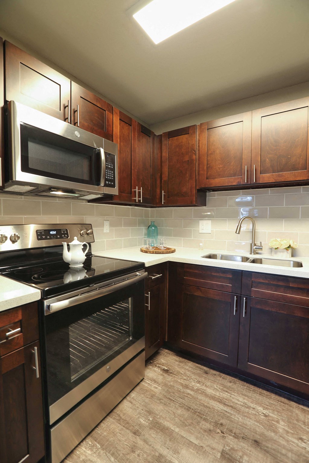 Kitchen featuring wood floors stainless appliances and granite counters