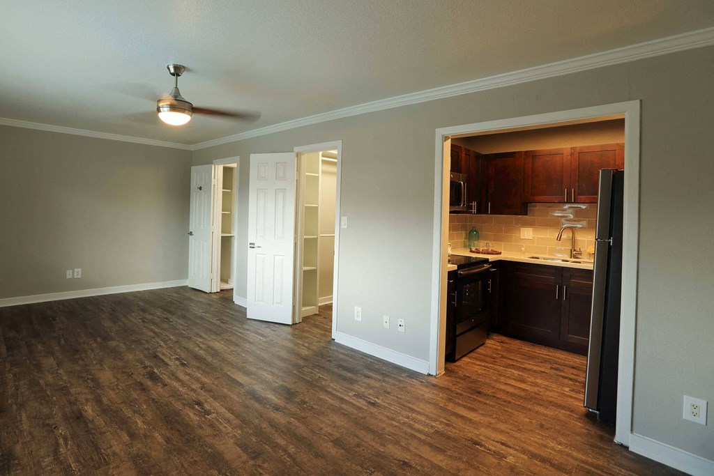 Studio apartment with kitchen and bathroom, featuring wood floors