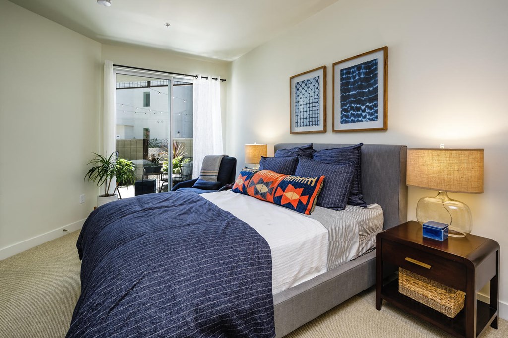 a bedroom with a large bed and a window