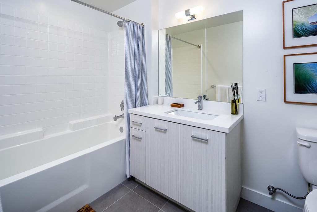 a bathroom with a sink and a tub and a mirror