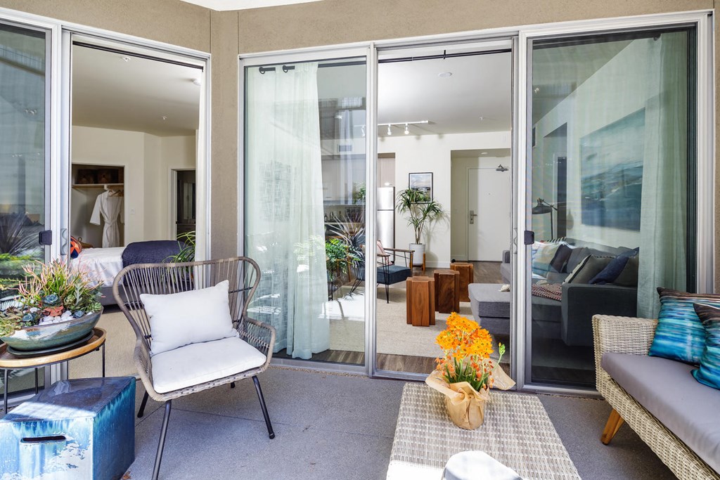 a living room with sliding glass doors and furniture