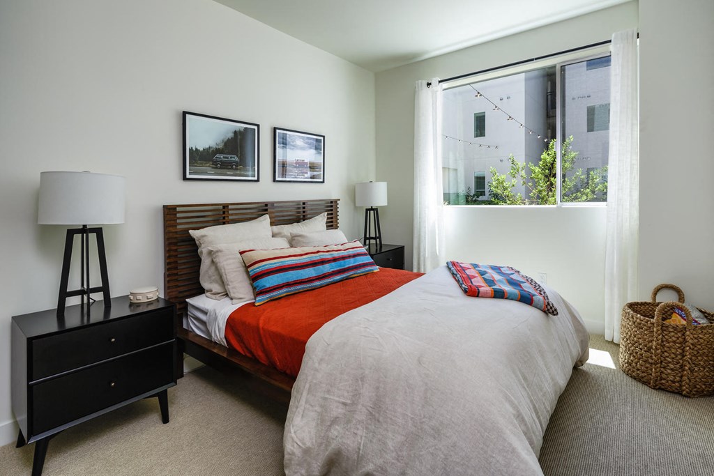 a bedroom with a bed and a large window
