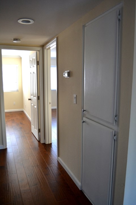 a view of the hallway with the closet door open and the door to the bedroom