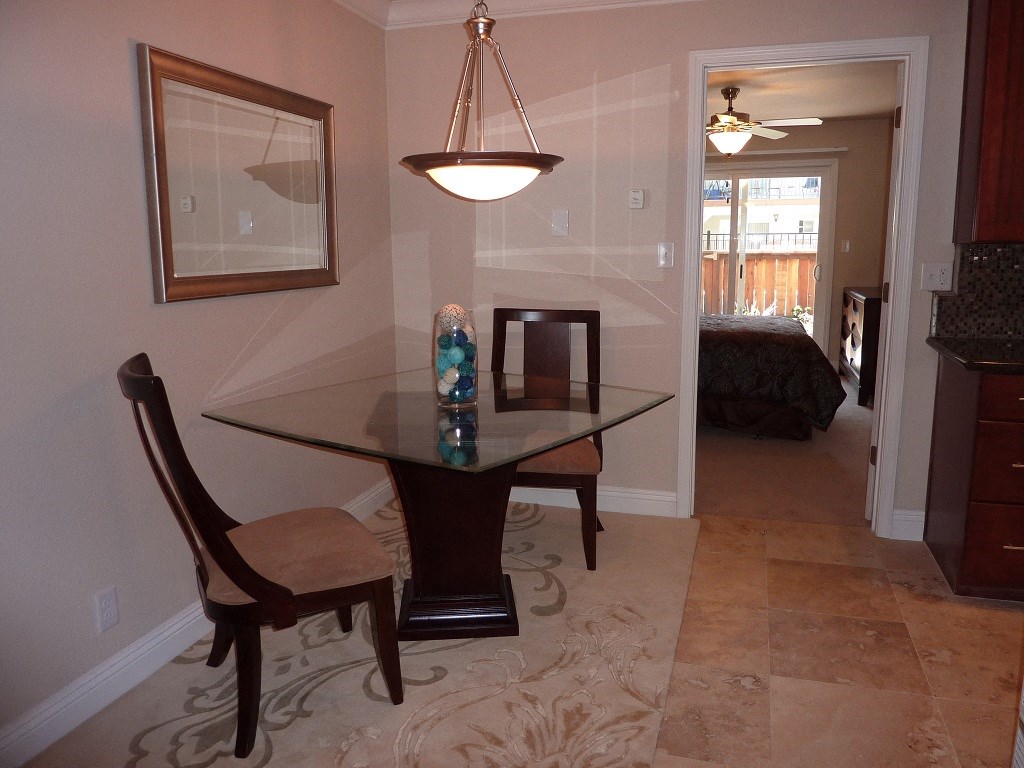 View of furnished model dining area with table and chairs