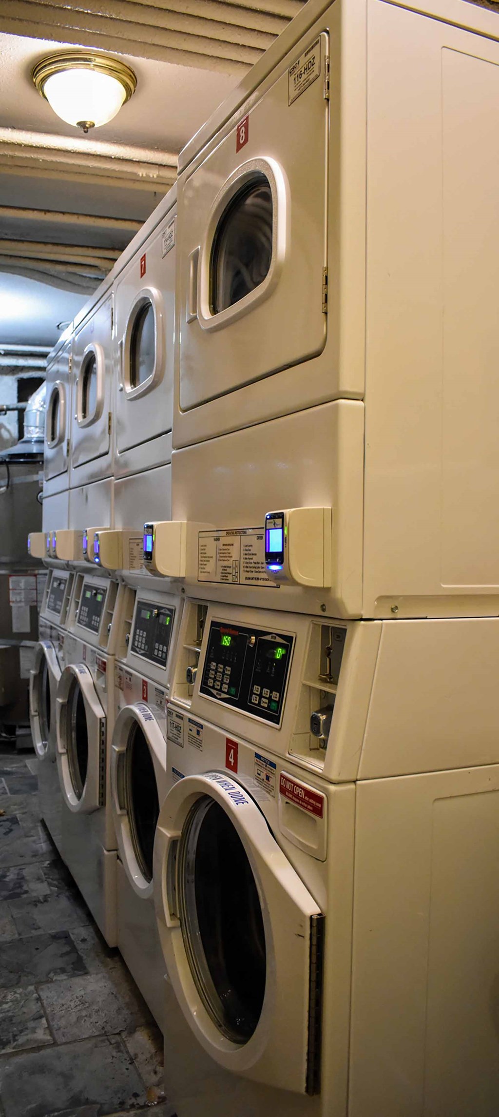 Laundry room with multiple washer and dryer units