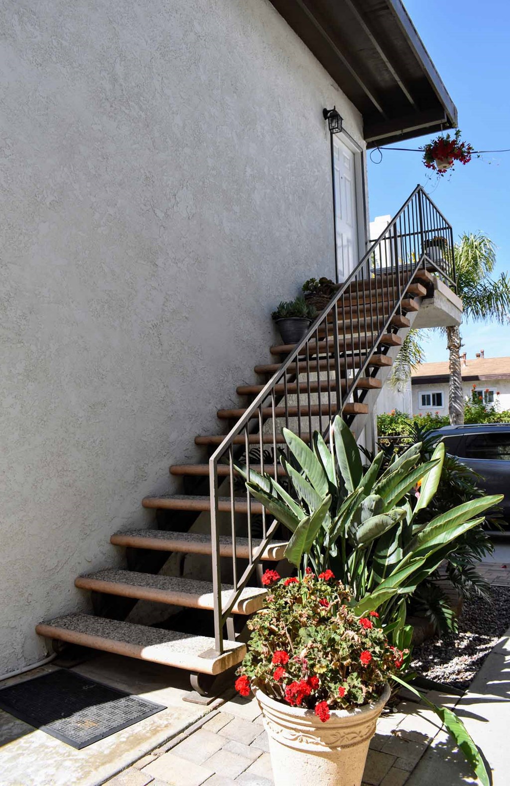 stairs up to a unit featuring colorful landscaping