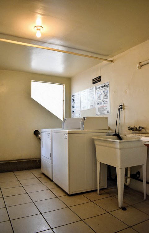 an empty kitchen with a sink and a washing machine