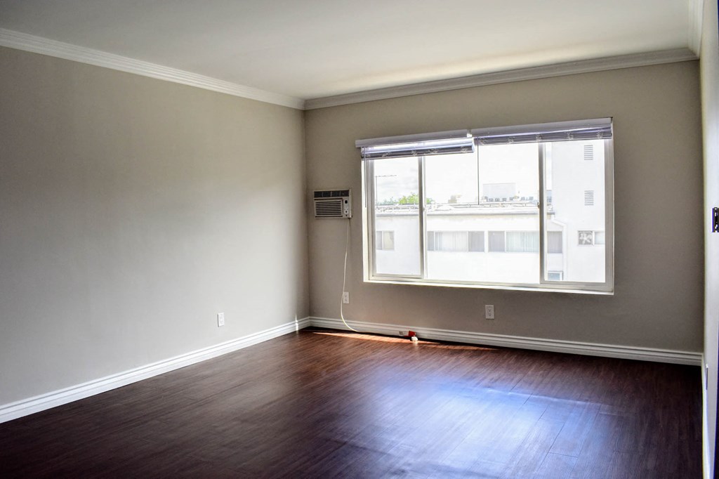 View of living room with wood look flooring and well lit window
