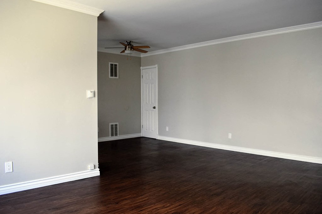 View from living area into dining area with wood look flooring and ceiling fan