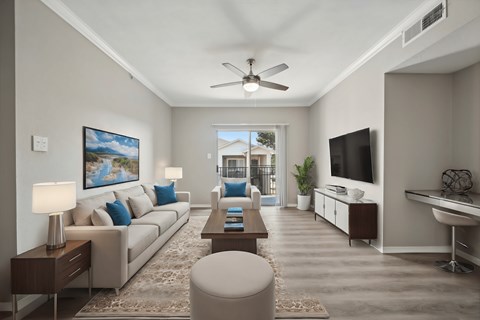 A well-lit living room with a large painting on the wall and a comfortable seating area.