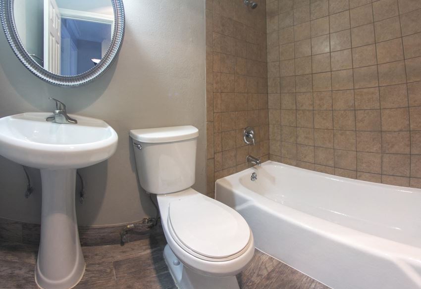 Bathroom Bathroom featuring tiled tub shower combo, toilet, sink and mirror