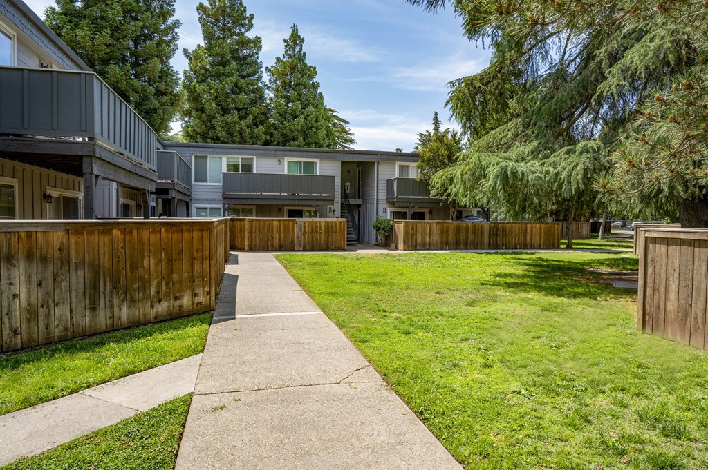 View of courtyard area with exterior of building with private patio/balcony