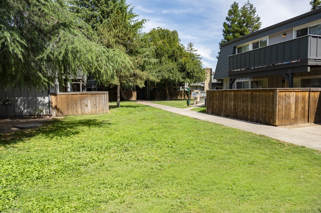 View of courtyard area with focus on private patio/balcony and shade covering
