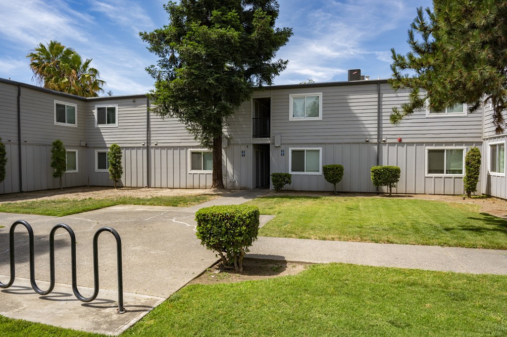 View of exterior buildings and courtyard area with bike racks