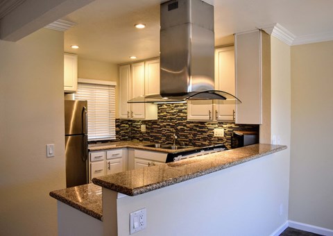 a kitchen with granite counter tops and a stove