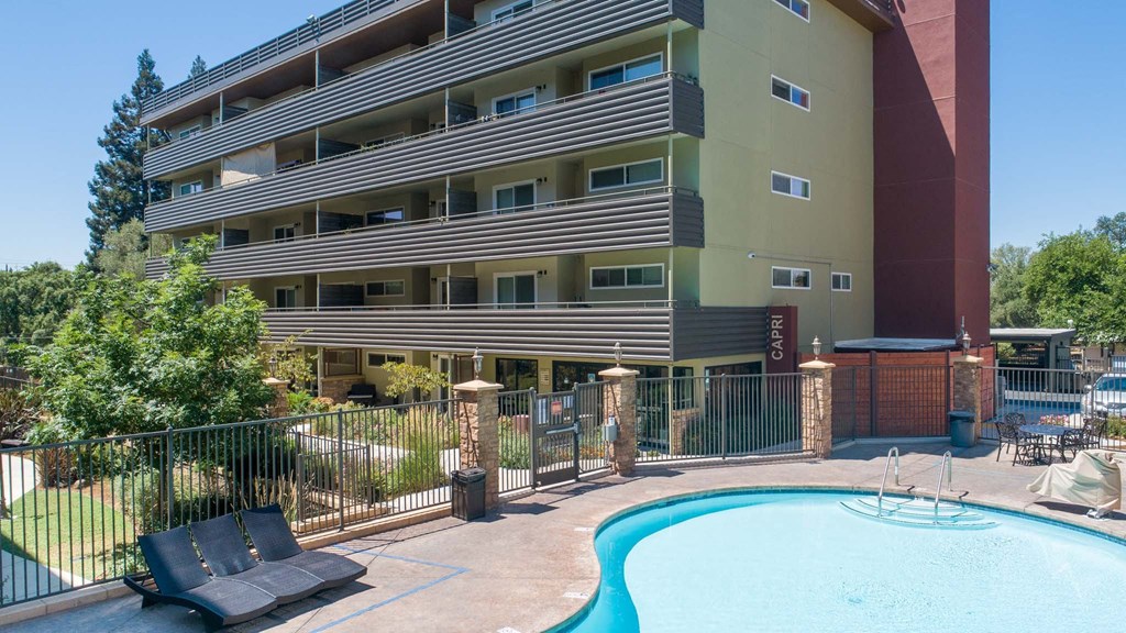 a large building with a swimming pool in front of it