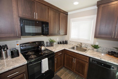 a kitchen with a stove microwave and sink