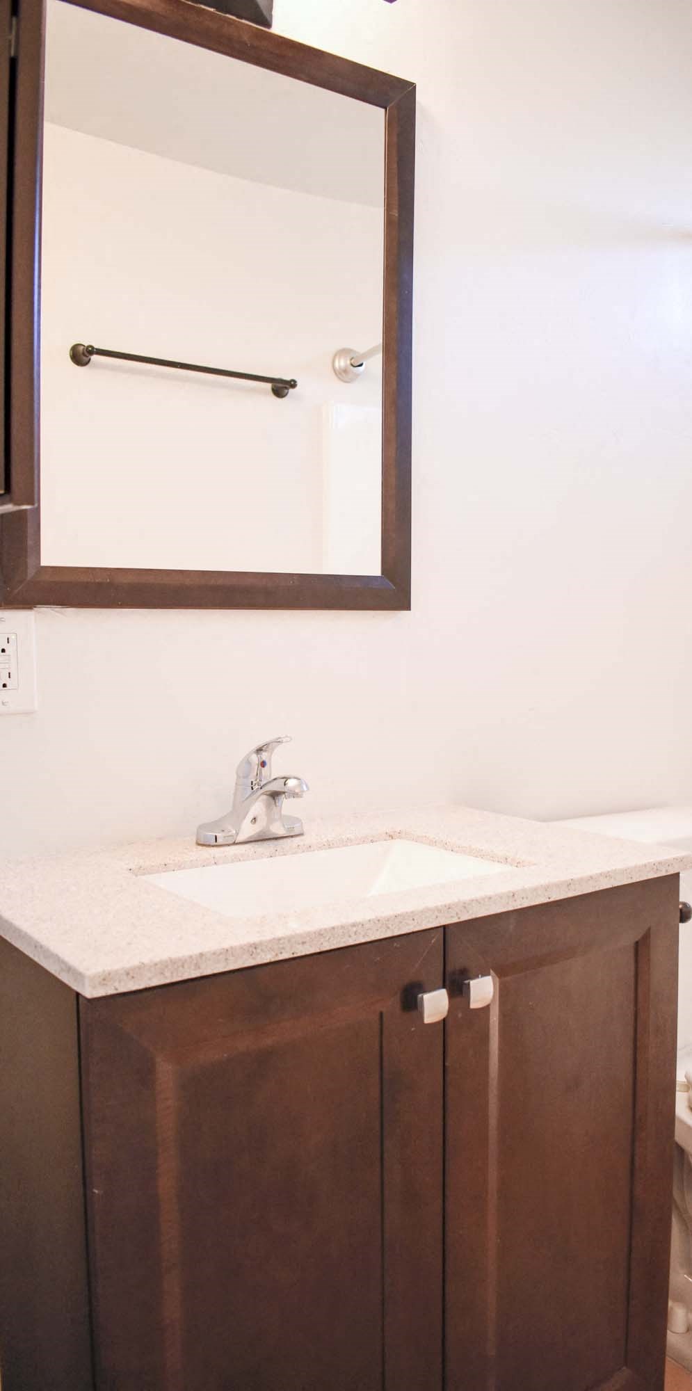 Bathroom vanity with in laid sink and mirror