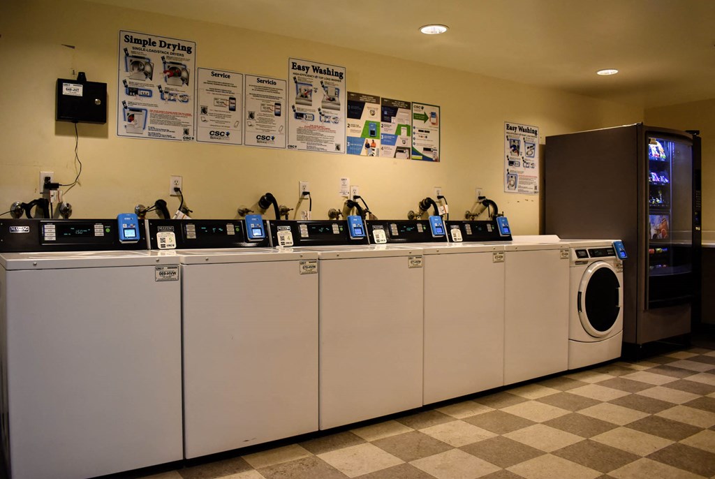 the laundry room is full of washers and dryers