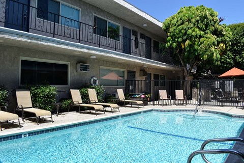 Community pool with lounge chairs and seating