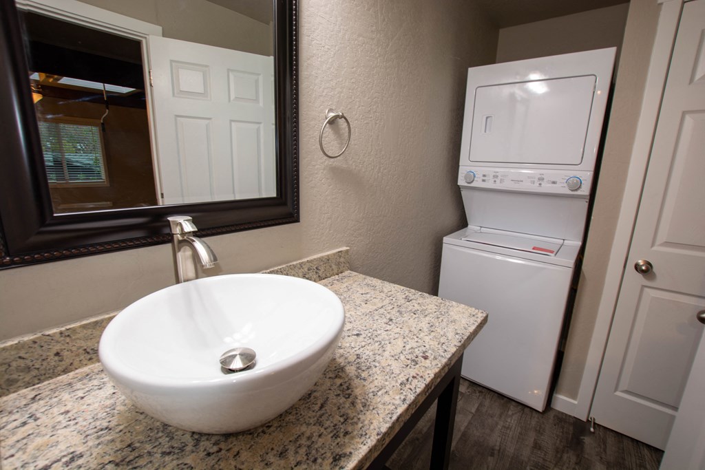 bathroom with vanity and stacked washer dryer
