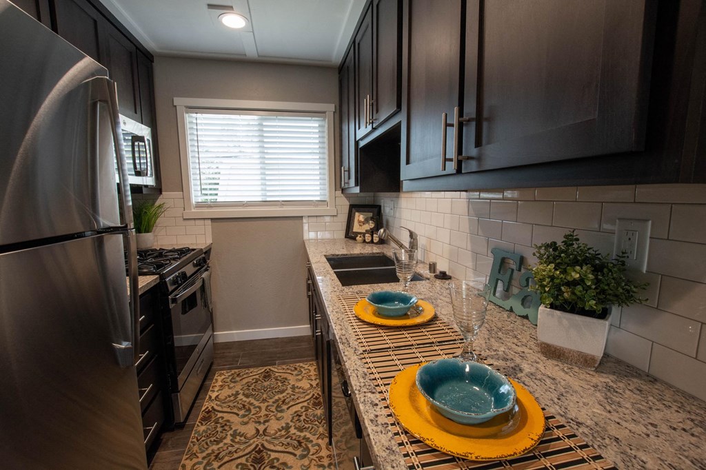 Kitchen with granite counters and stainless appliance