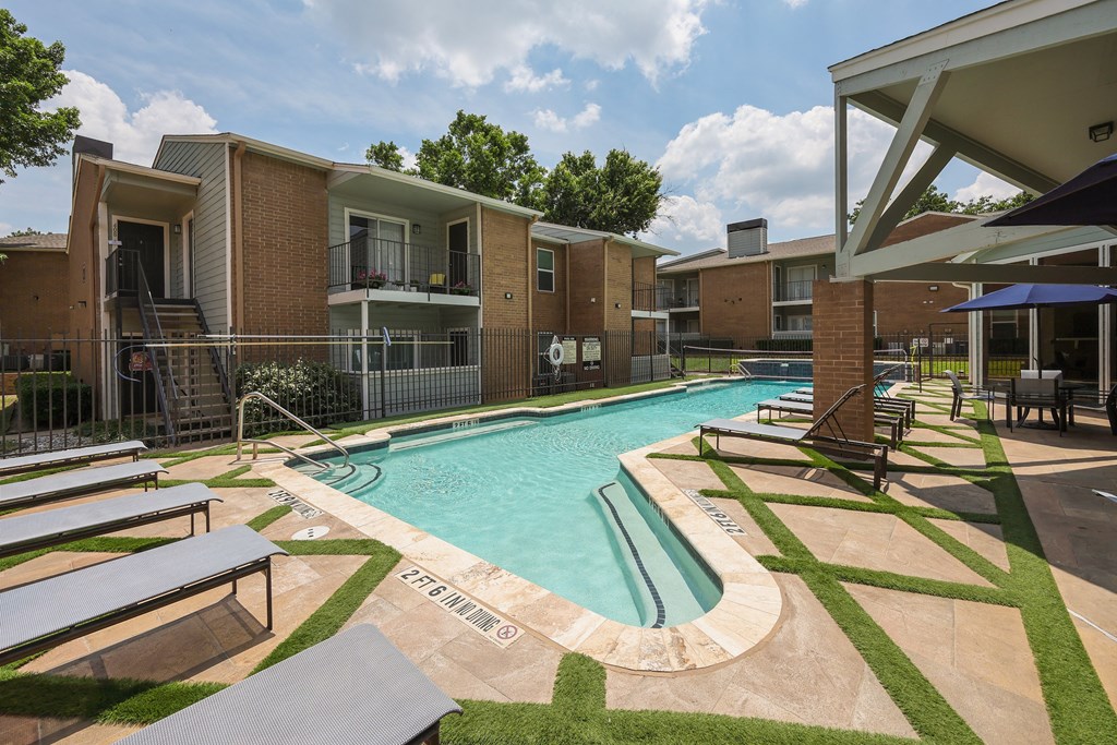 View of gated pool area with lounge chairs and sitting area