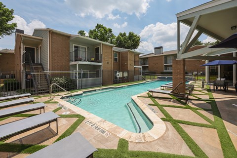 View of gated pool area with lounge chairs and sitting area